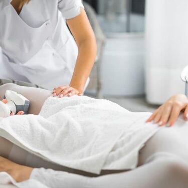 Client receiving an Endermologie cellulite reduction treatment on the upper thigh