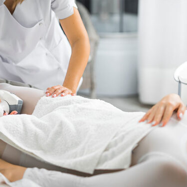 Woman lying on the bed during LPG Endermologie Body Massage session