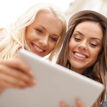 Two women discovering a business profile on LinkHub+