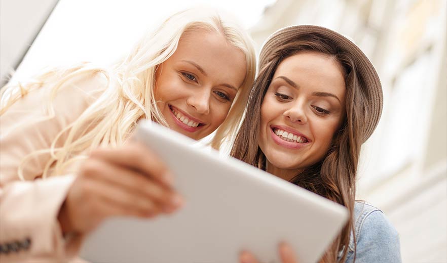 Two women discovering a business profile on LinkHub+