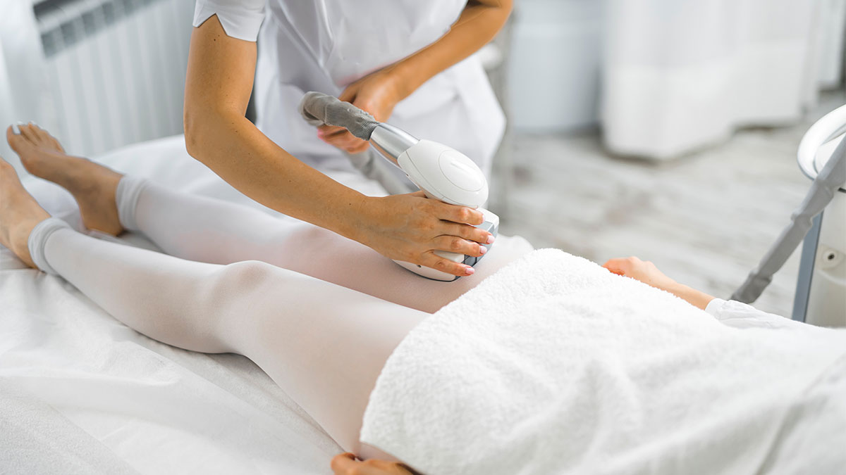 Endermologie body treatment on the thigh using a mechanical roller device, often used to support lymphatic flow and post-sedentary swelling.
