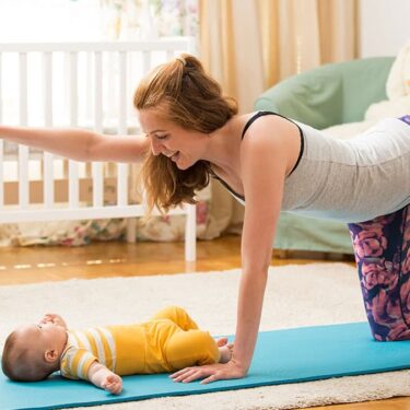 Postpartum mother practicing gentle core and mobility exercise at home with baby nearby